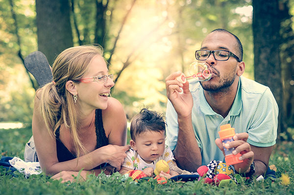 family blowing bubbles thinking about switching to Marquette NFP